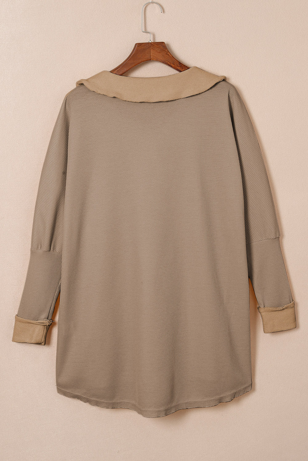 A stylish green waffle knit long sleeve top with buttons, perfect for casual wear and layering.