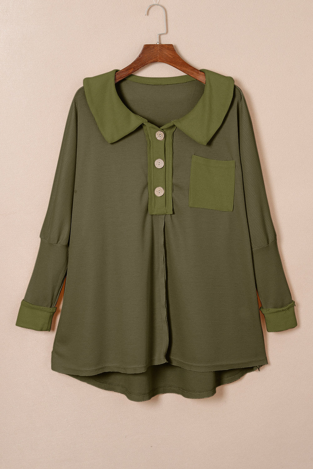 A stylish green waffle knit long sleeve top with buttons, perfect for casual wear and layering.