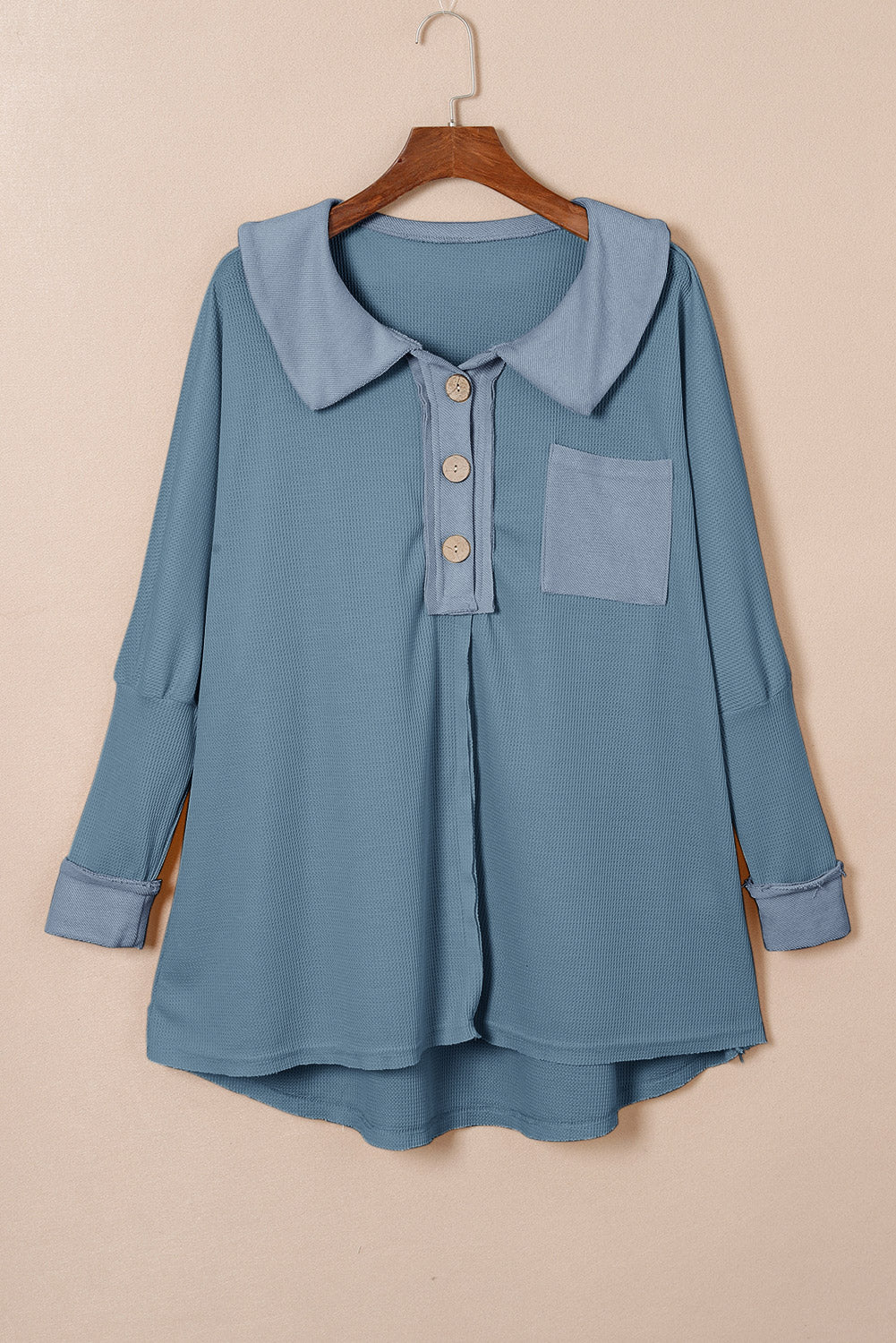 A stylish green waffle knit long sleeve top with buttons, perfect for casual wear and layering.