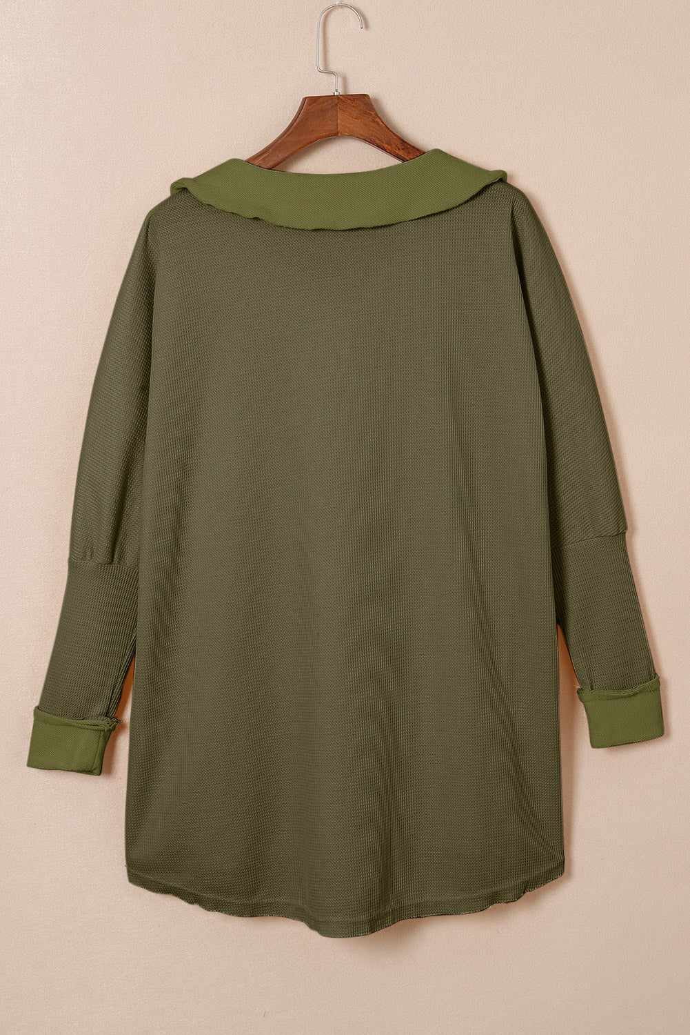 A stylish green waffle knit long sleeve top with buttons, perfect for casual wear and layering.