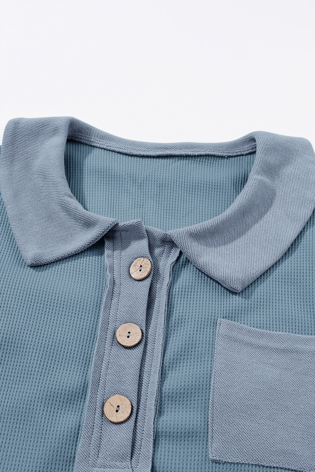 A stylish green waffle knit long sleeve top with buttons, perfect for casual wear and layering.