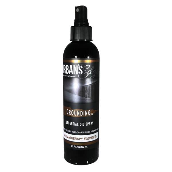 Grounding Essential Oil Spray bottle with a mist, featuring natural ingredients and gemstones for holistic healing.