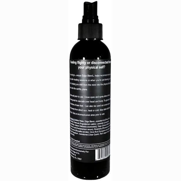 Grounding Essential Oil Spray bottle with a mist, featuring natural ingredients and gemstones for holistic healing.