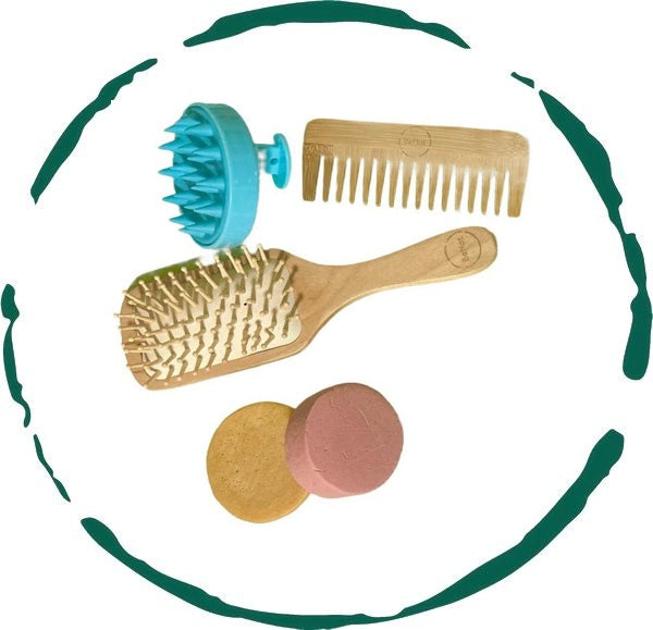 Hair Care Bundle featuring shampoo bar, conditioner bar, bamboo comb, wooden brush, and scalp massager arranged aesthetically.