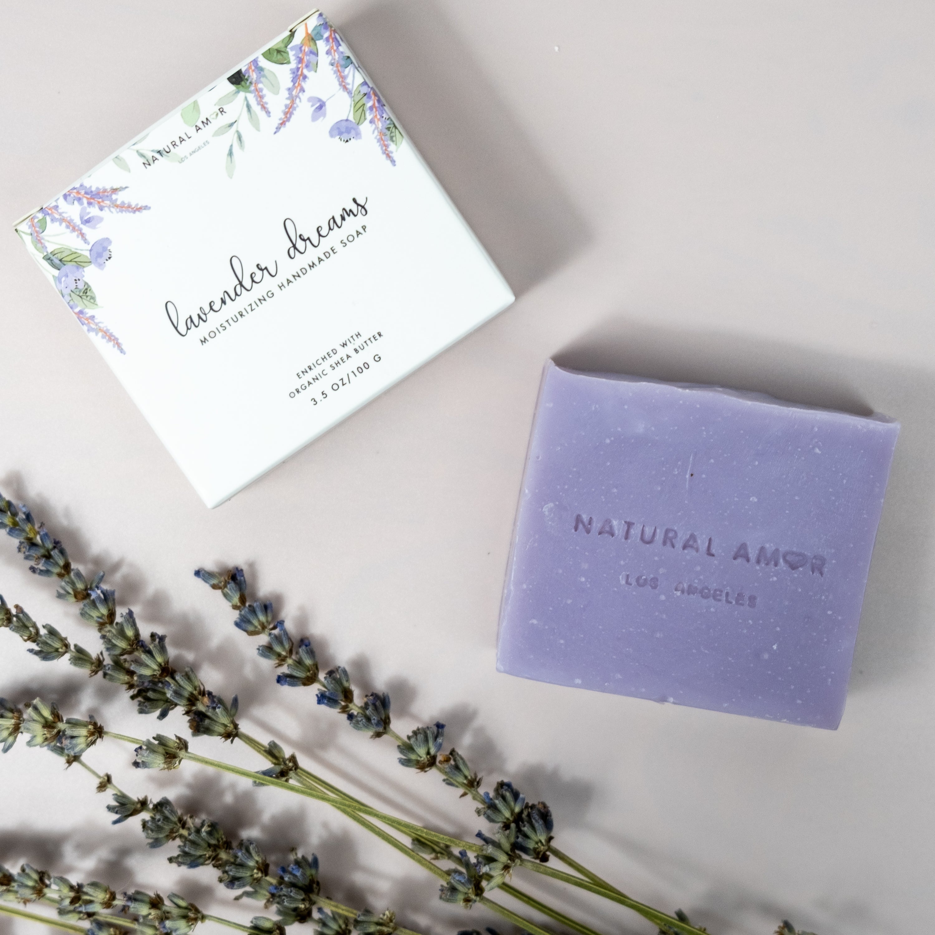 Set of three handmade vegan soaps in lavender, rose, and citrus scents, beautifully packaged.