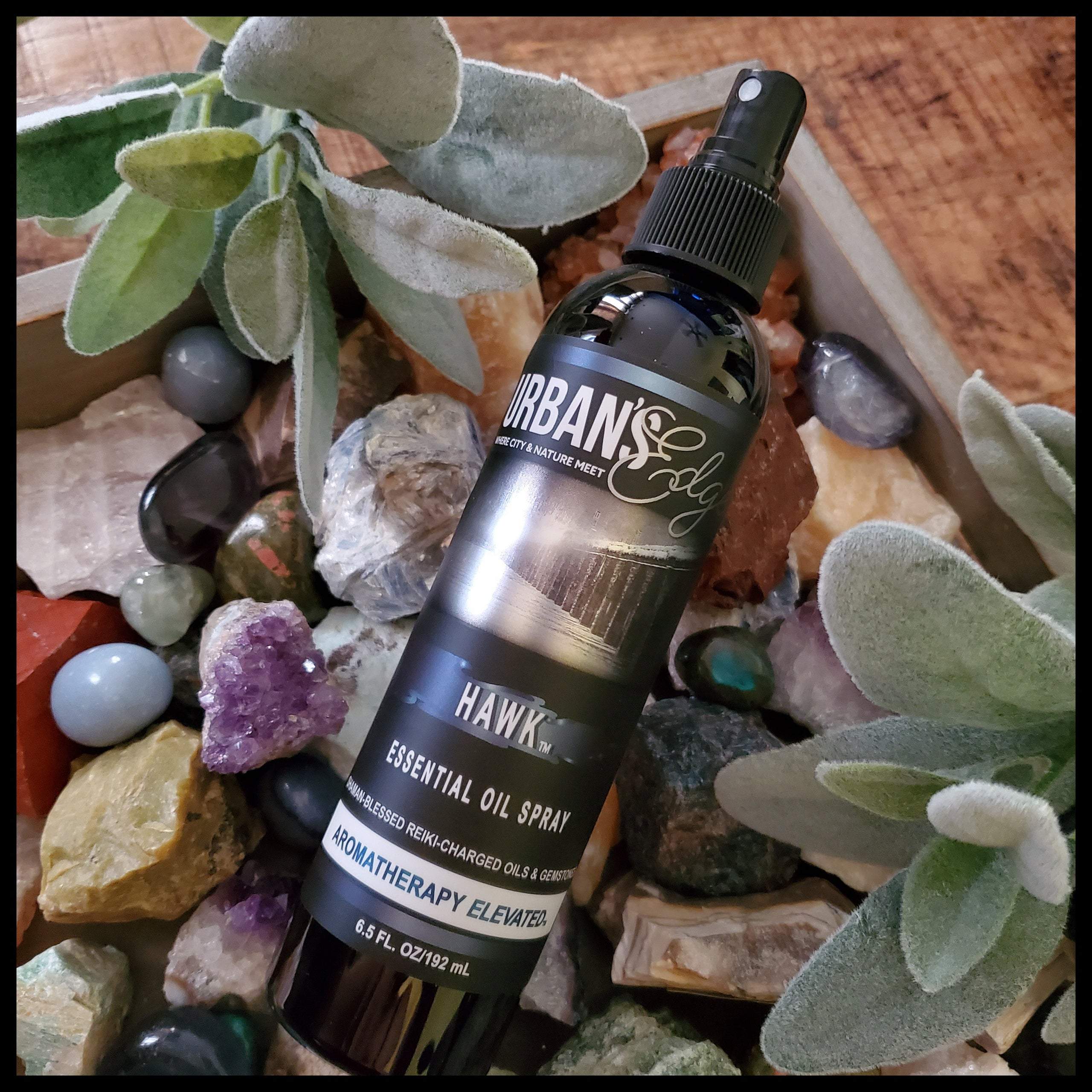 Hawk Essential Oil Spray bottle with a unique blend of essential oils, featuring a sleek design and gemstones for enhanced benefits.