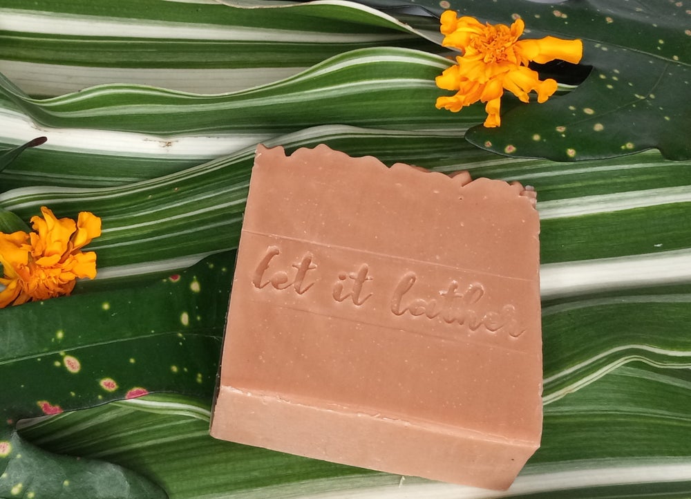 Hibiscus & French Pink Clay Bath Soap with natural ingredients, showcasing its vibrant color and texture.