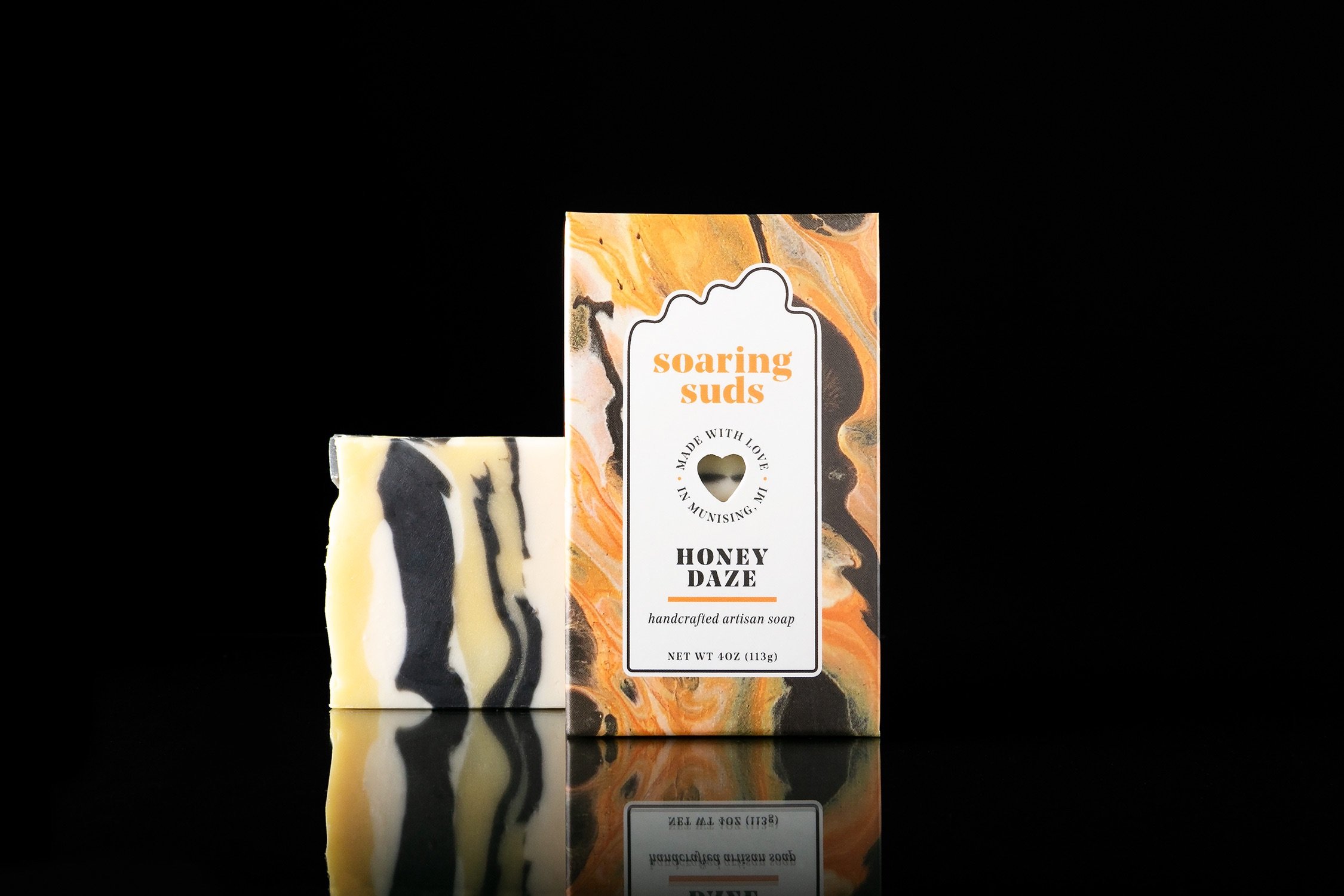 Honey Daze Artisan Soap bar featuring a blend of honey, lemon, almond, and ginger, handcrafted with natural ingredients.