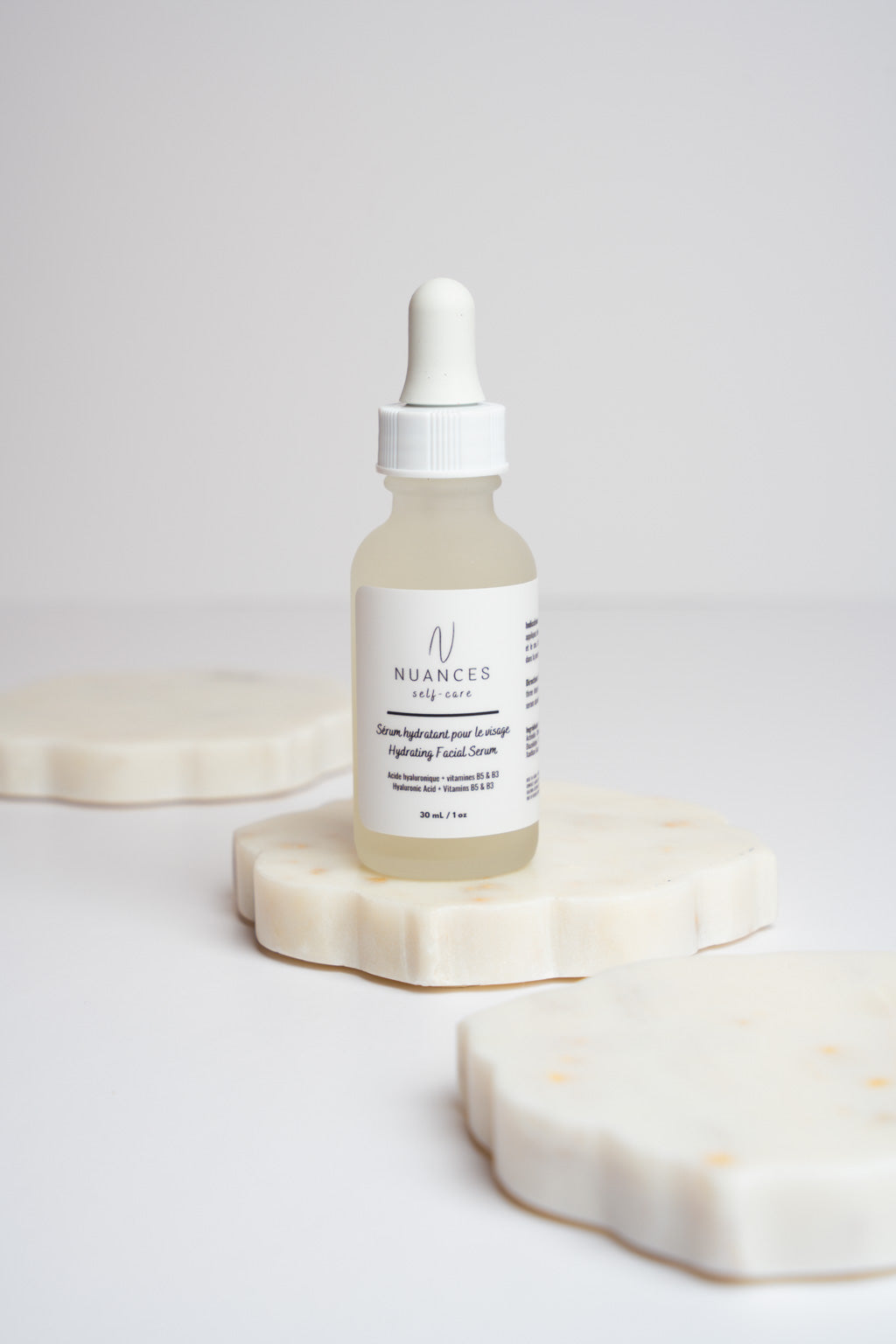 A bottle of Hydrating Facial Serum with a dropper, showcasing its lightweight texture and natural ingredients.