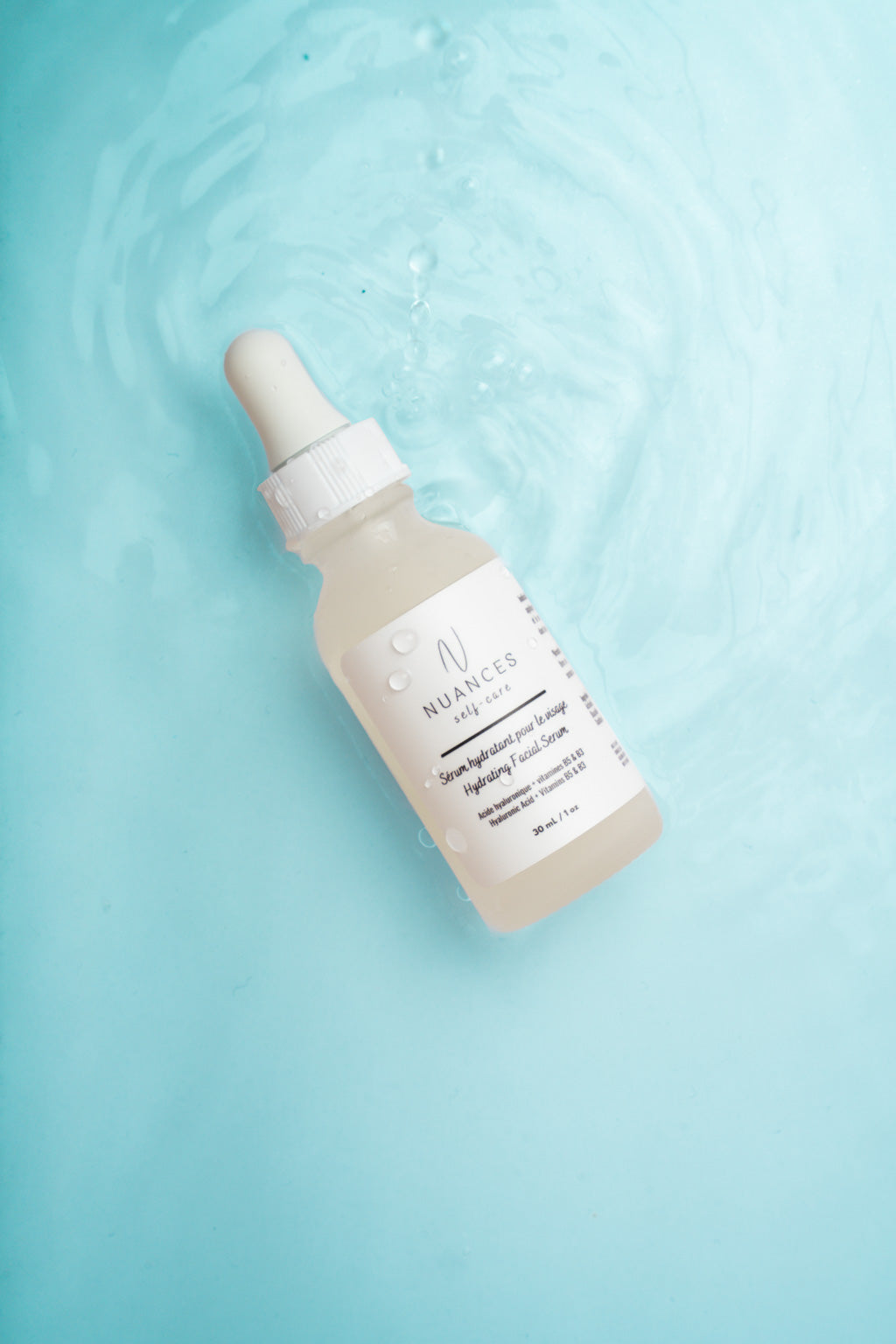 A bottle of Hydrating Facial Serum with a dropper, showcasing its lightweight texture and natural ingredients.