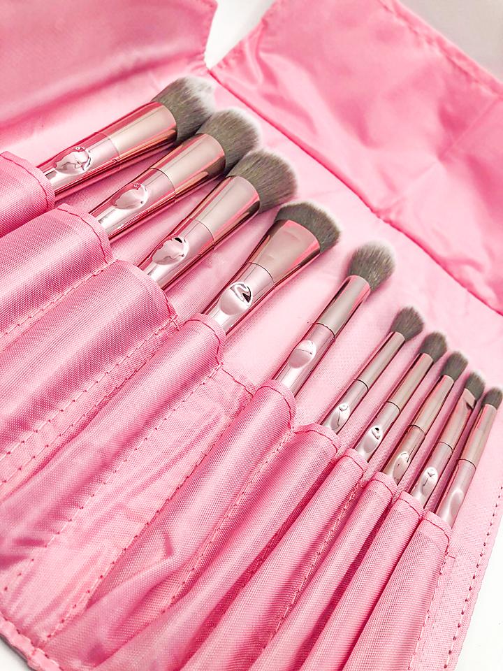 I Am Light Brush Collection featuring 10 rose gold brushes, a stylish carrying case, and a heart-shaped mirror.