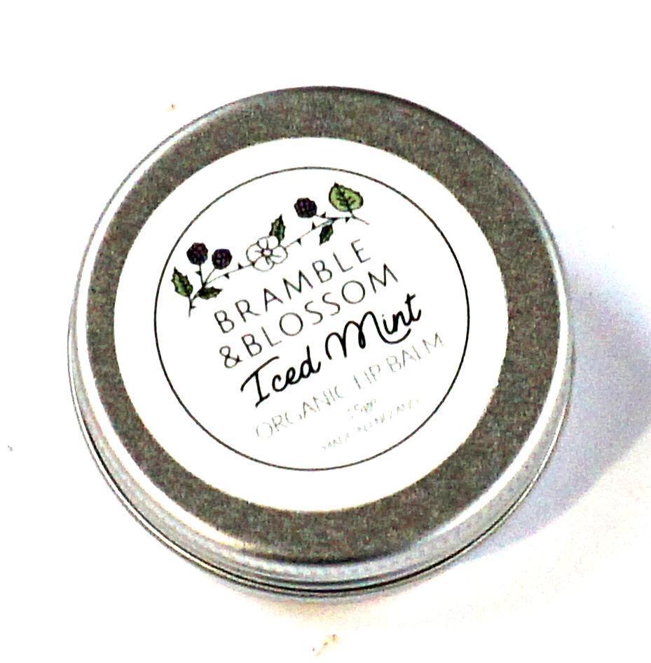 A compact tin of Iced Mint Lip Balm by Bramble and Blossom, showcasing its refreshing minty flavor and luxurious vegan ingredients.