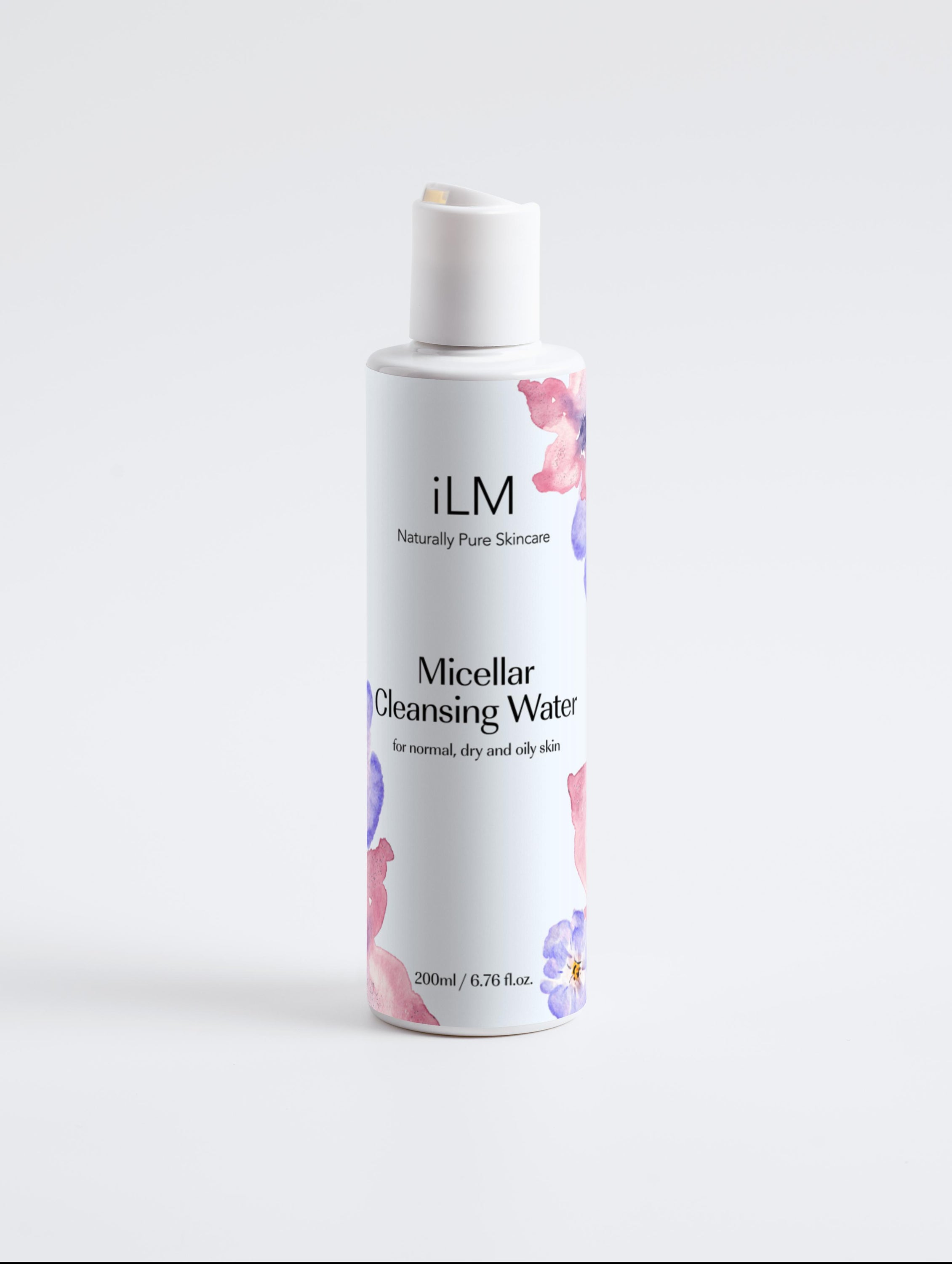 Bottle of iLM Micellar Cleansing Water with a refreshing blue label, surrounded by cotton pads and flowers.