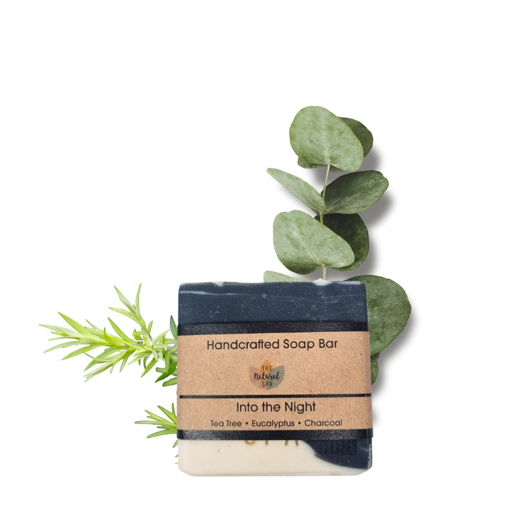 Into the Night Soap featuring tea tree, eucalyptus, and charcoal, handcrafted with unique designs in a natural setting.