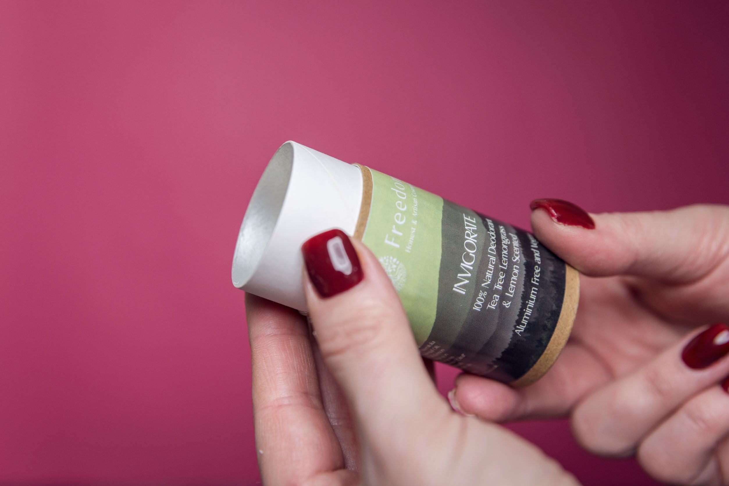 Invigorate Natural Vegan Deodorant in a biodegradable cardboard tube, featuring a fresh Tea Tree, Lemongrass, and Lemon scent.