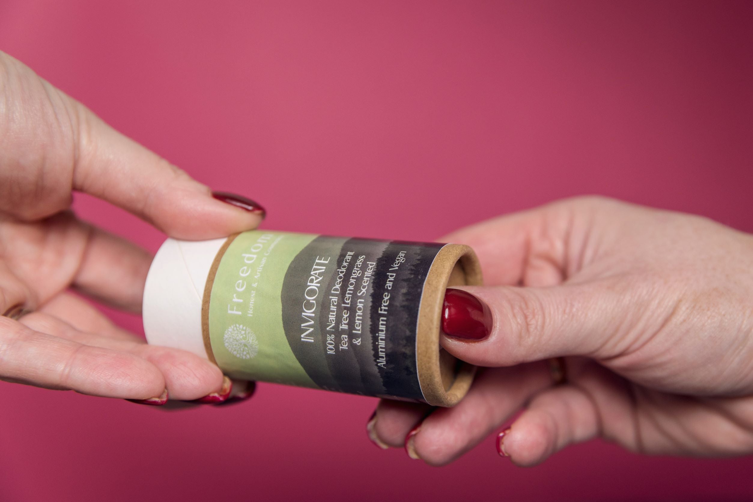 Invigorate Natural Vegan Deodorant in a biodegradable cardboard tube, featuring a fresh Tea Tree, Lemongrass, and Lemon scent.