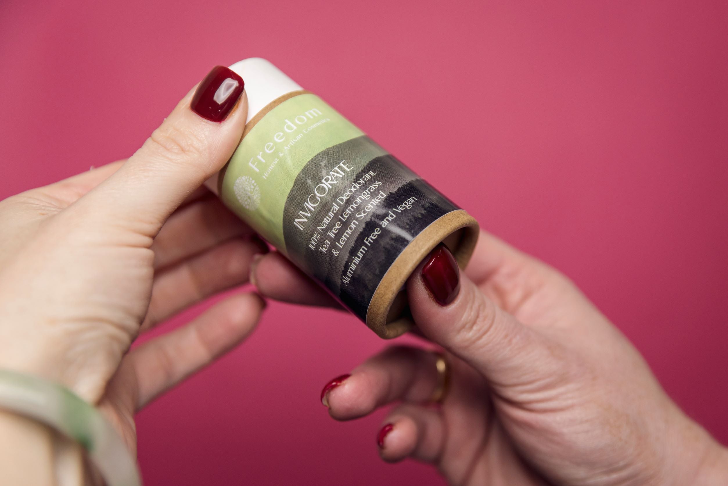 Invigorate Natural Vegan Deodorant in a biodegradable cardboard tube, featuring a fresh Tea Tree, Lemongrass, and Lemon scent.