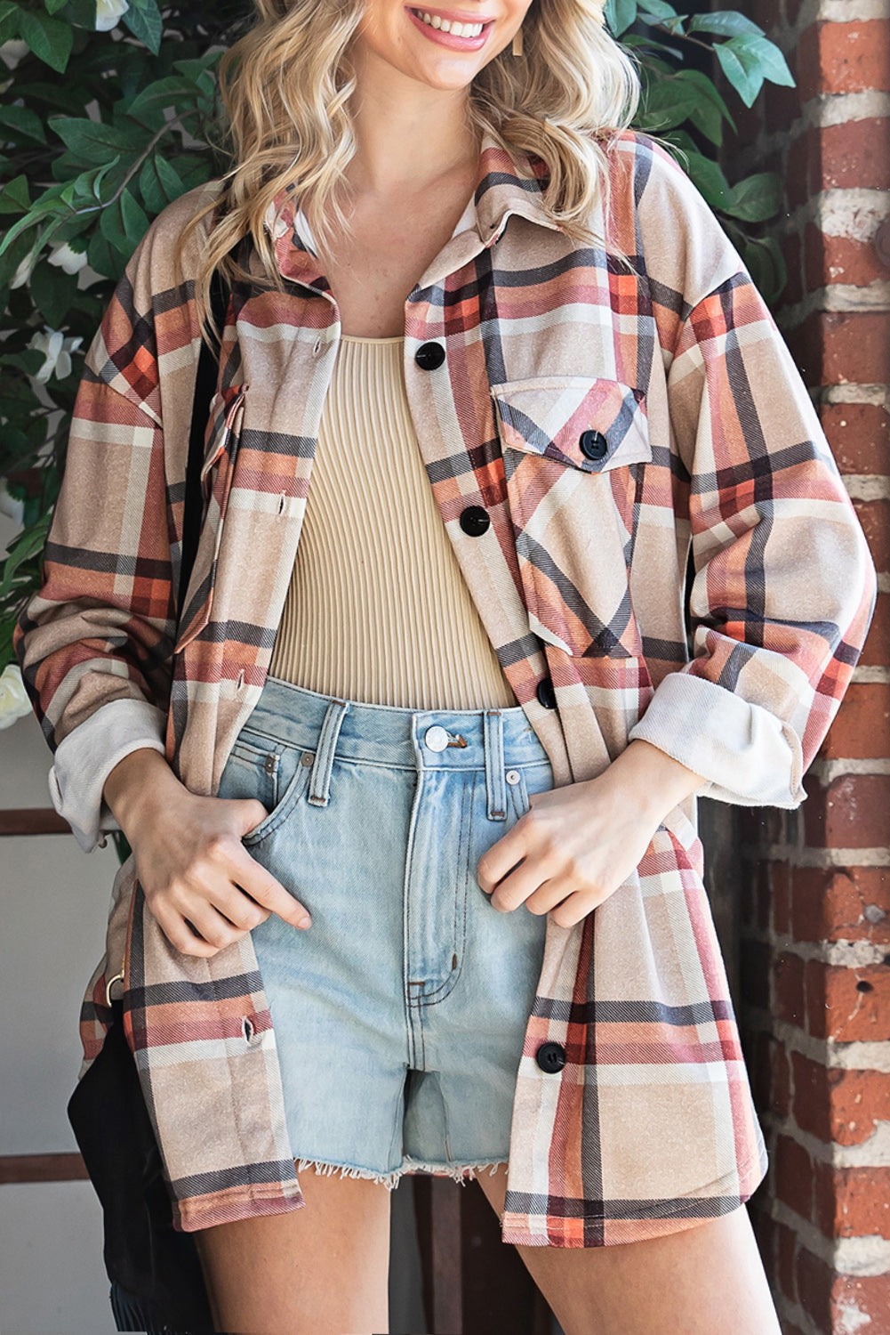 Khaki oversized plaid shacket with button closure and chest pockets, perfect for layering.