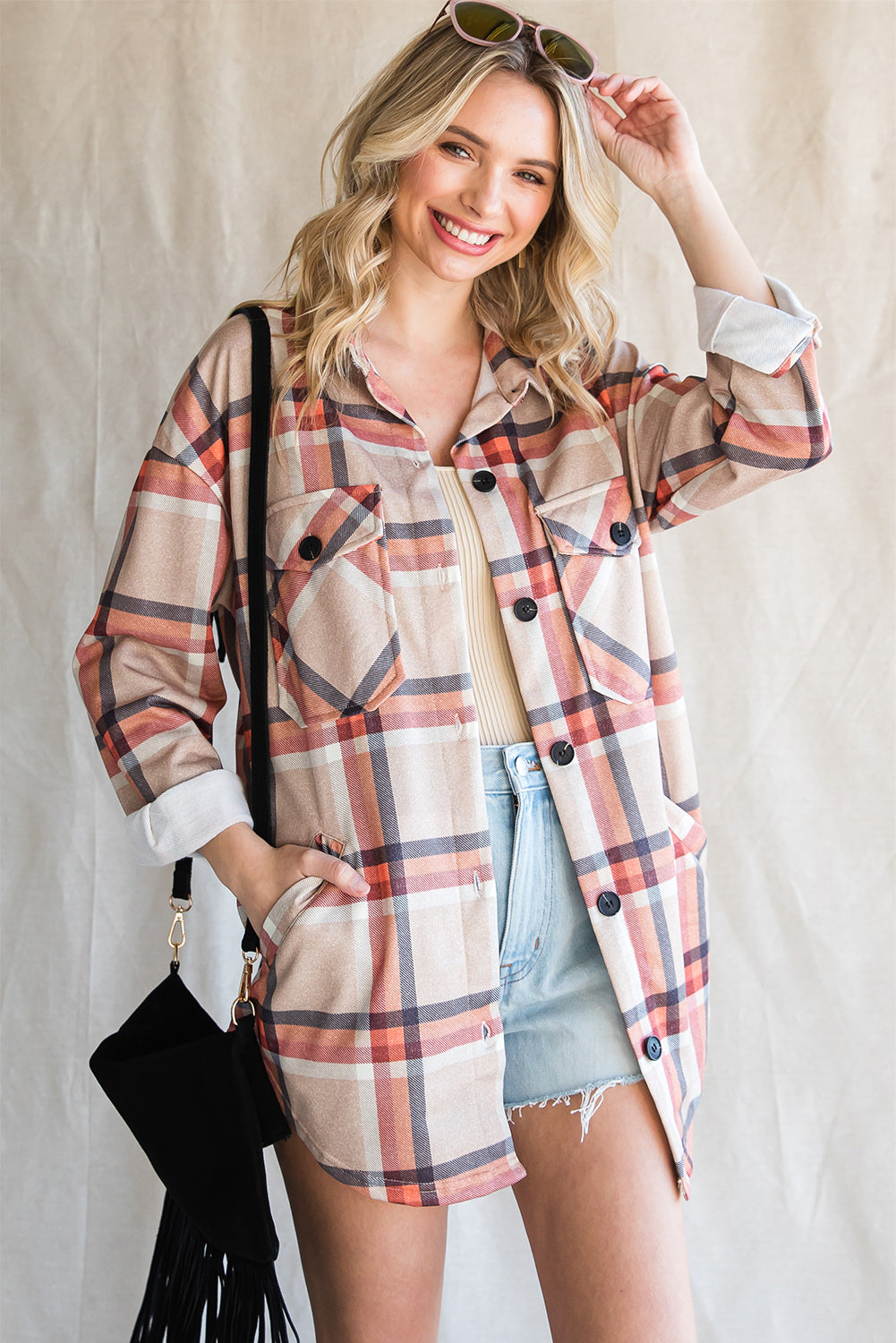 Khaki oversized plaid shacket with button closure and chest pockets, perfect for layering.