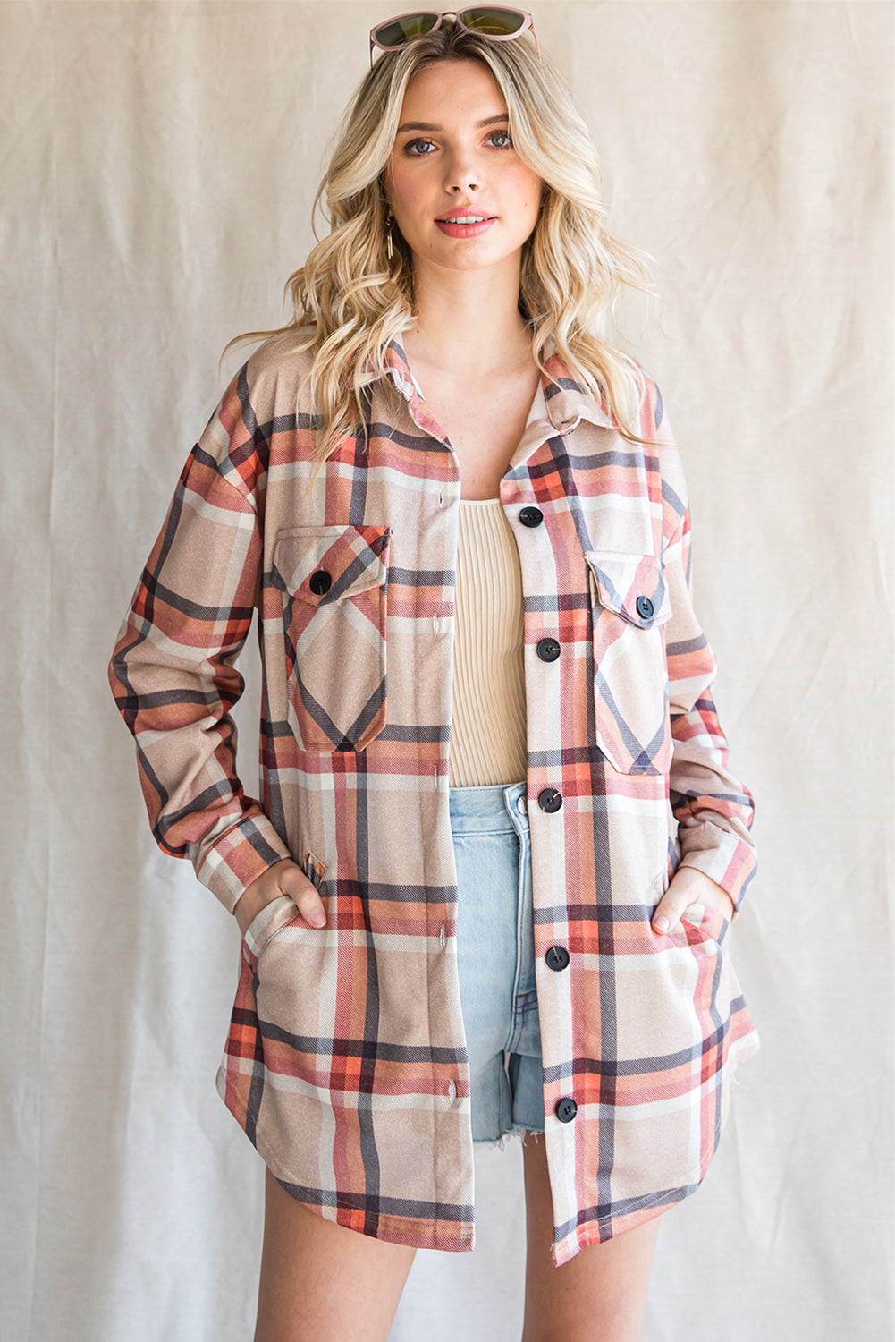 Khaki oversized plaid shacket with button closure and chest pockets, perfect for layering.