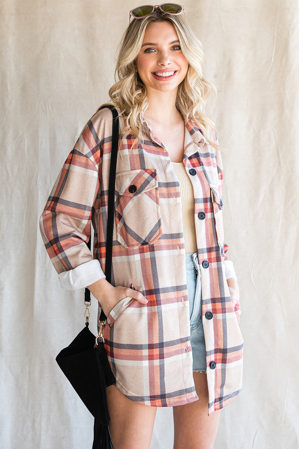 Khaki oversized plaid shacket with button closure and chest pockets, perfect for layering.