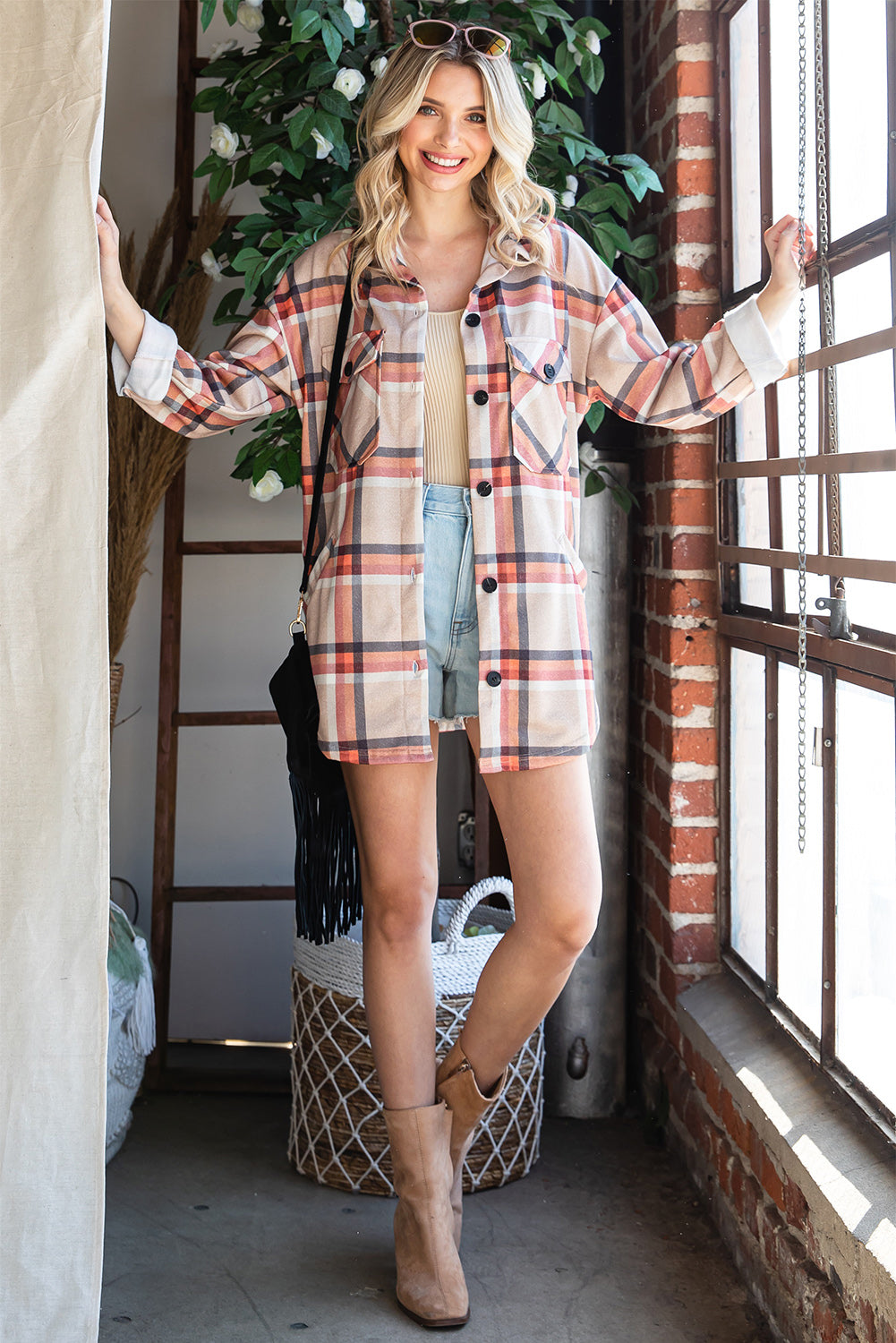 Khaki oversized plaid shacket with button closure and chest pockets, perfect for layering.