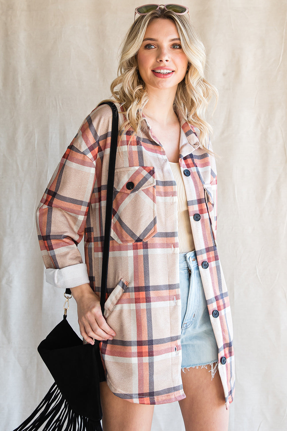 Khaki oversized plaid shacket with button closure and chest pockets, perfect for layering.