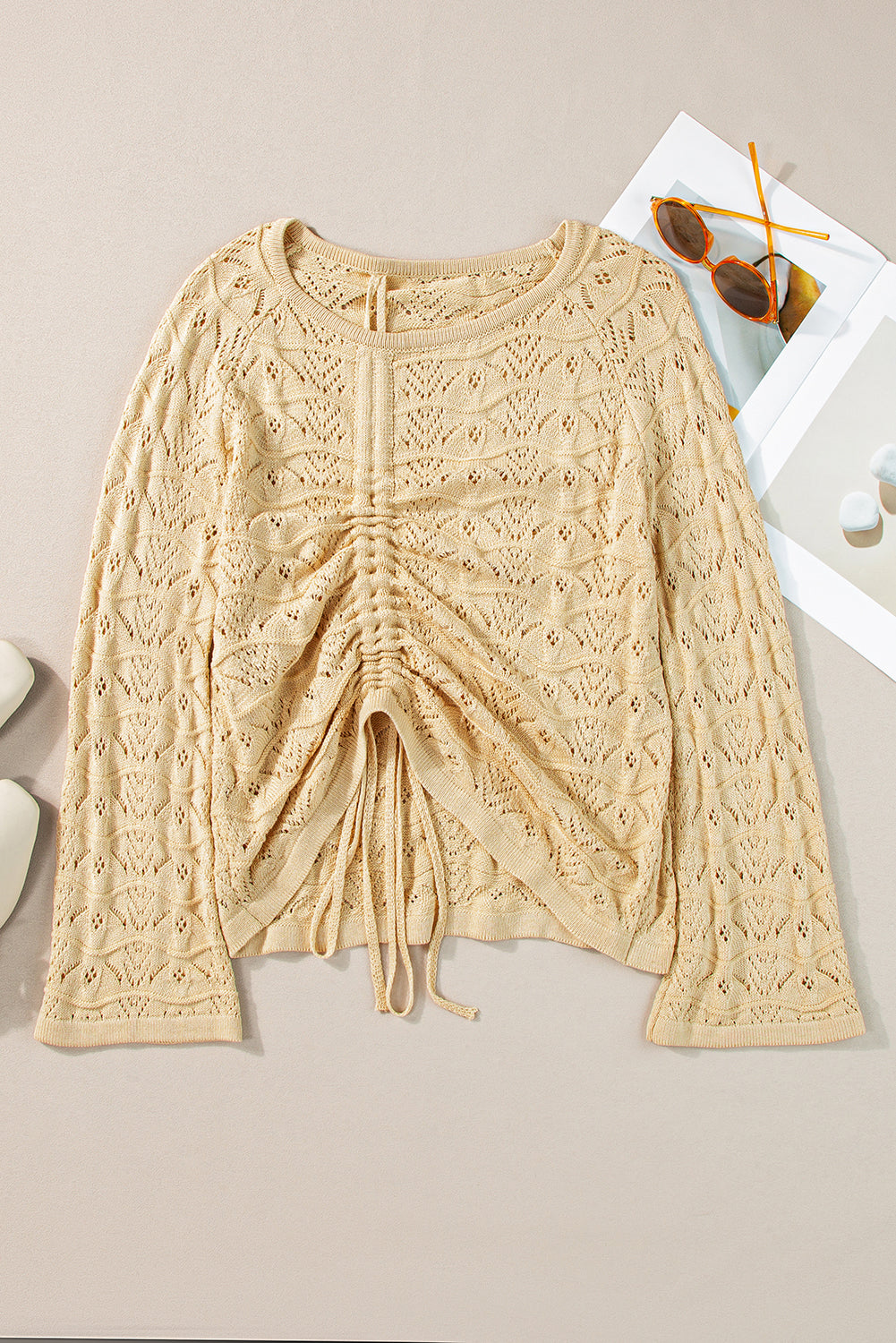 Khaki Hollowed Knit Asymmetric Drawstring Sweater showcasing a trendy hollowed knit design with drawstring accents and an asymmetric neckline.