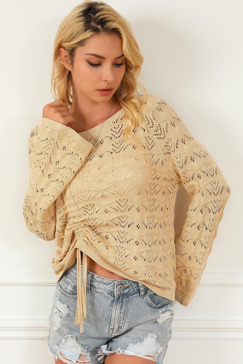 Khaki Hollowed Knit Asymmetric Drawstring Sweater showcasing a trendy hollowed knit design with drawstring accents and an asymmetric neckline.