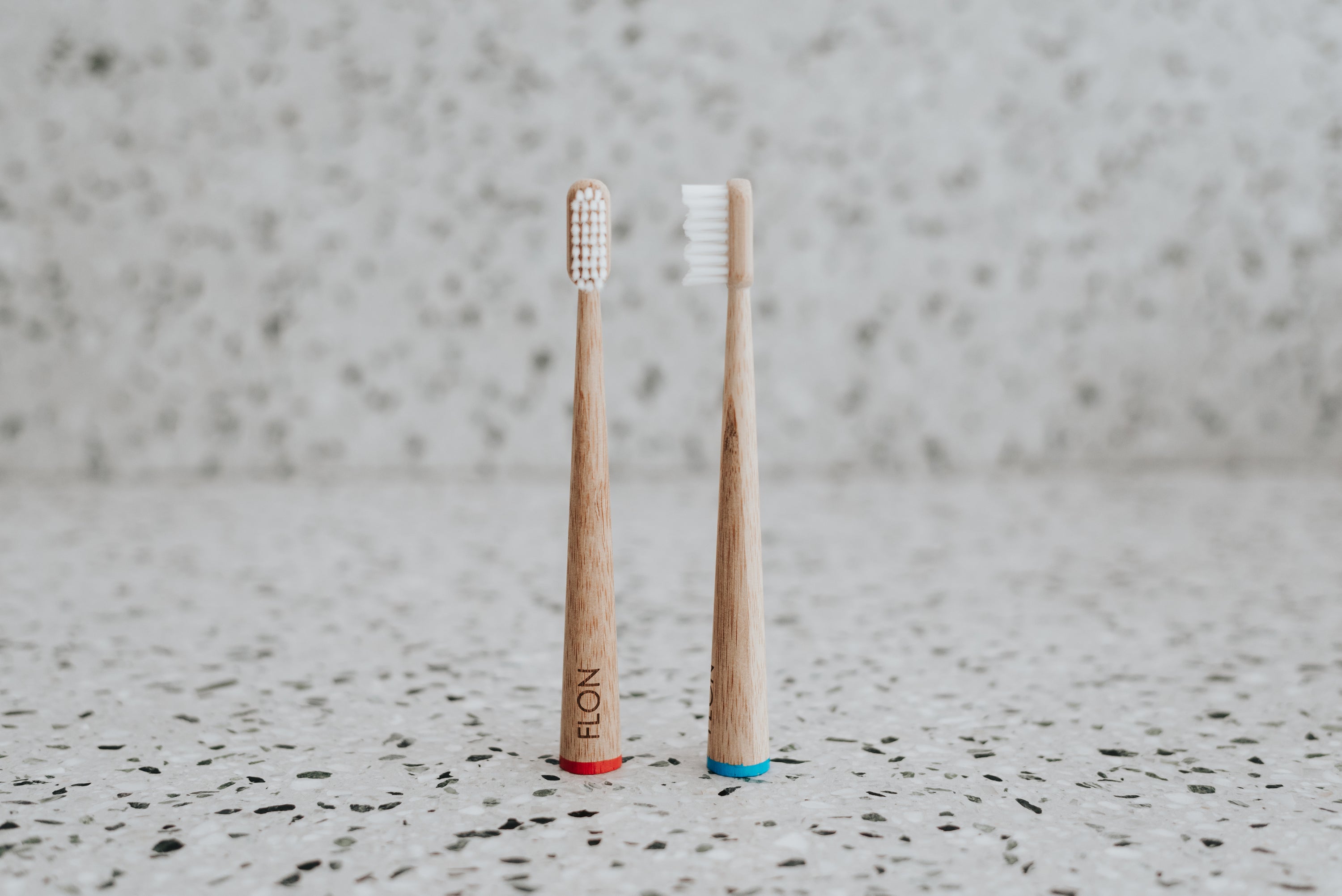 A set of colorful Kids Bamboo Toothbrushes with biodegradable bamboo handles and soft bristles, displayed in eco-friendly packaging.