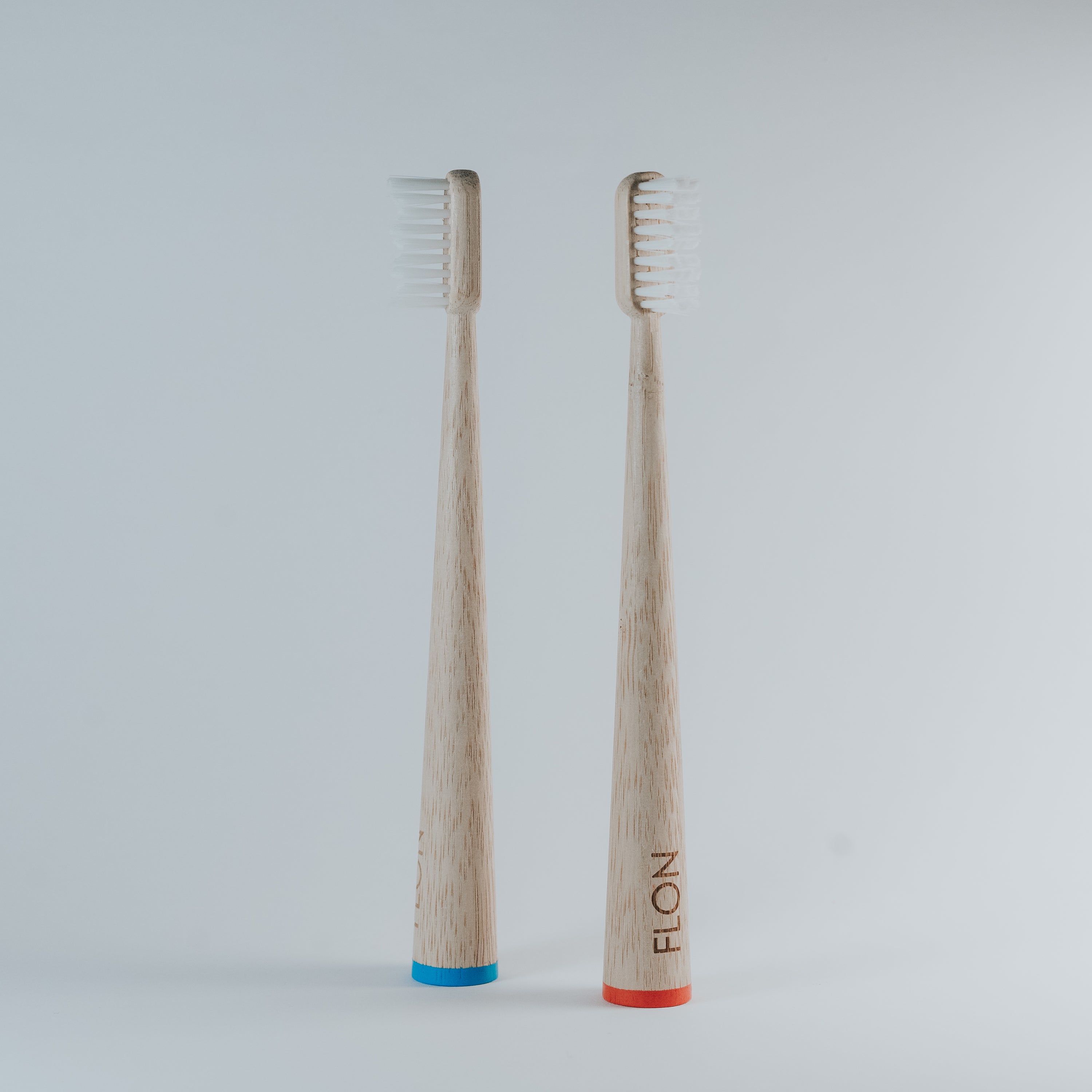 A set of colorful Kids Bamboo Toothbrushes with biodegradable bamboo handles and soft bristles, displayed in eco-friendly packaging.