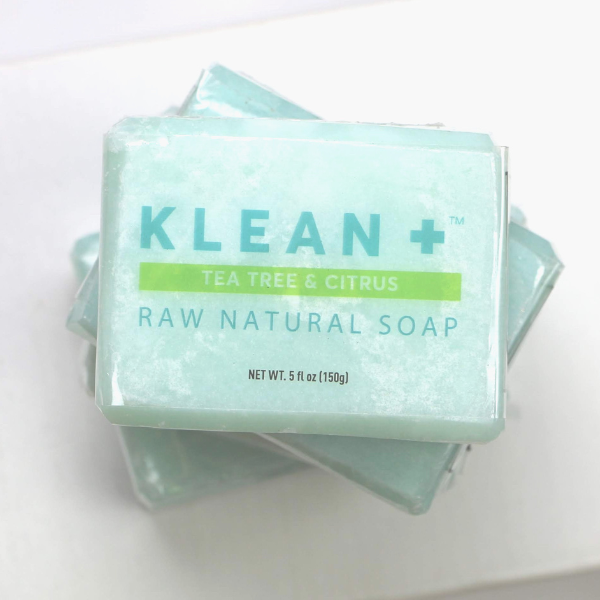 Klean + Raw Natural Soap bar with tea tree and citrus scent, showcasing its natural ingredients and eco-friendly packaging.