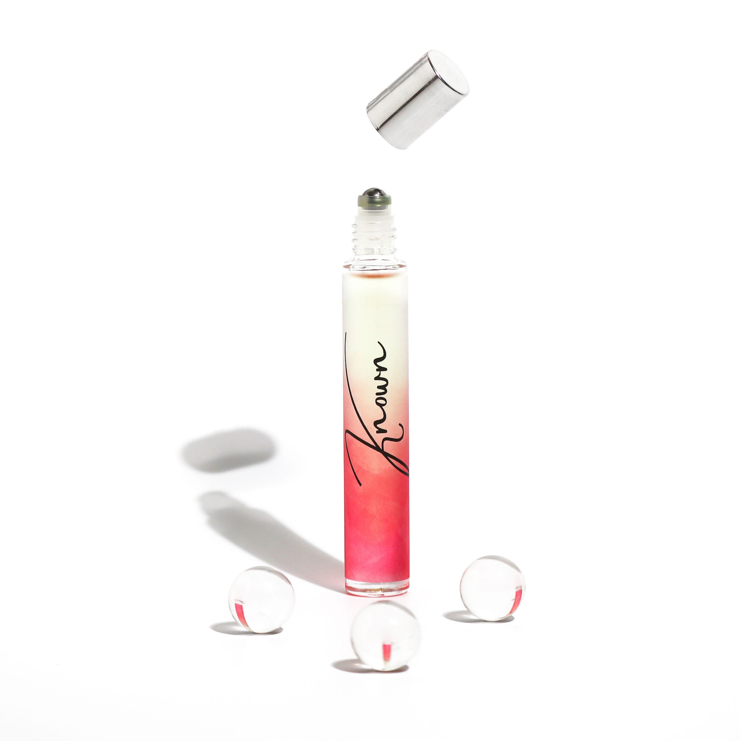 Known Rollerball Perfume in a sleek bottle with a rollerball applicator, elegantly packaged for gifting.