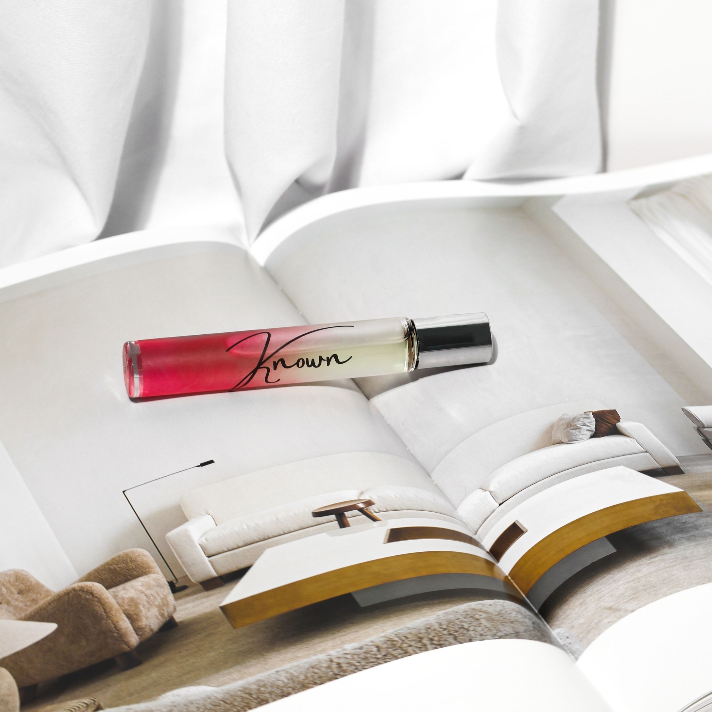 Known Rollerball Perfume in a sleek bottle with a rollerball applicator, elegantly packaged for gifting.