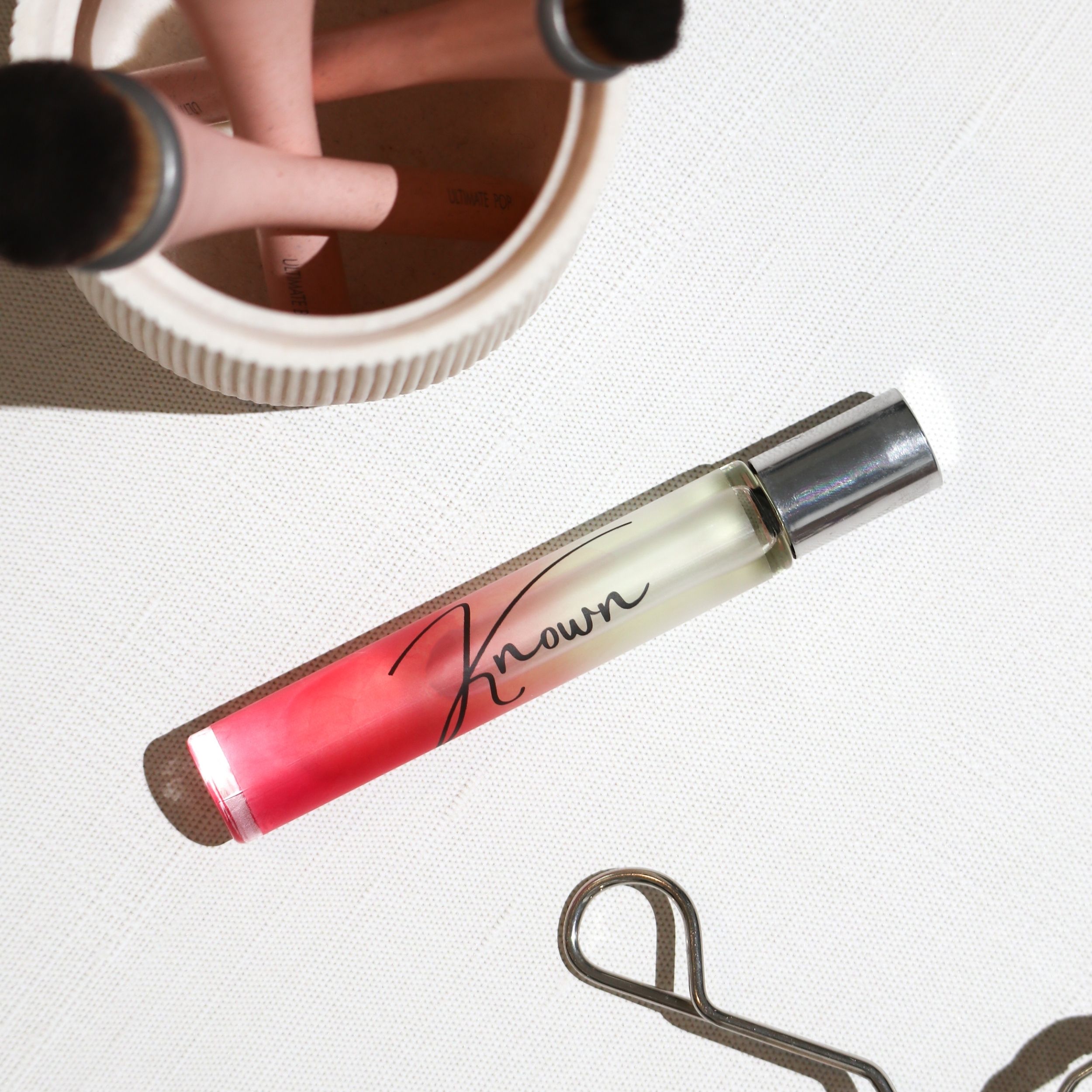 Known Rollerball Perfume in a sleek bottle with a rollerball applicator, elegantly packaged for gifting.