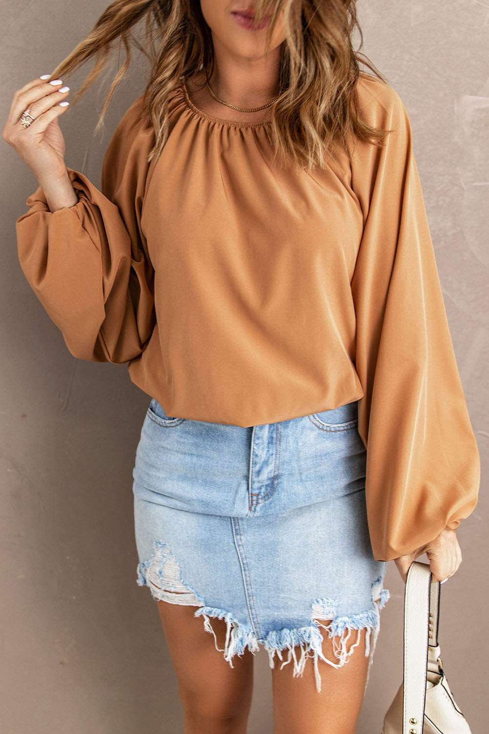 A stylish Lantern Sleeve Loose Blouse featuring a relaxed fit, round neck, and bubble sleeves, perfect for modern women.