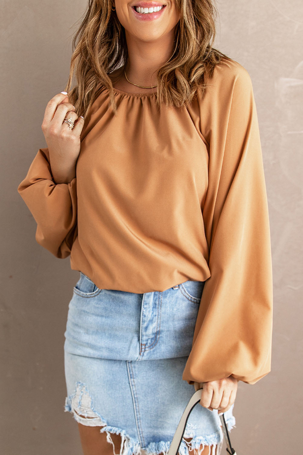 A stylish Lantern Sleeve Loose Blouse featuring a relaxed fit, round neck, and bubble sleeves, perfect for modern women.