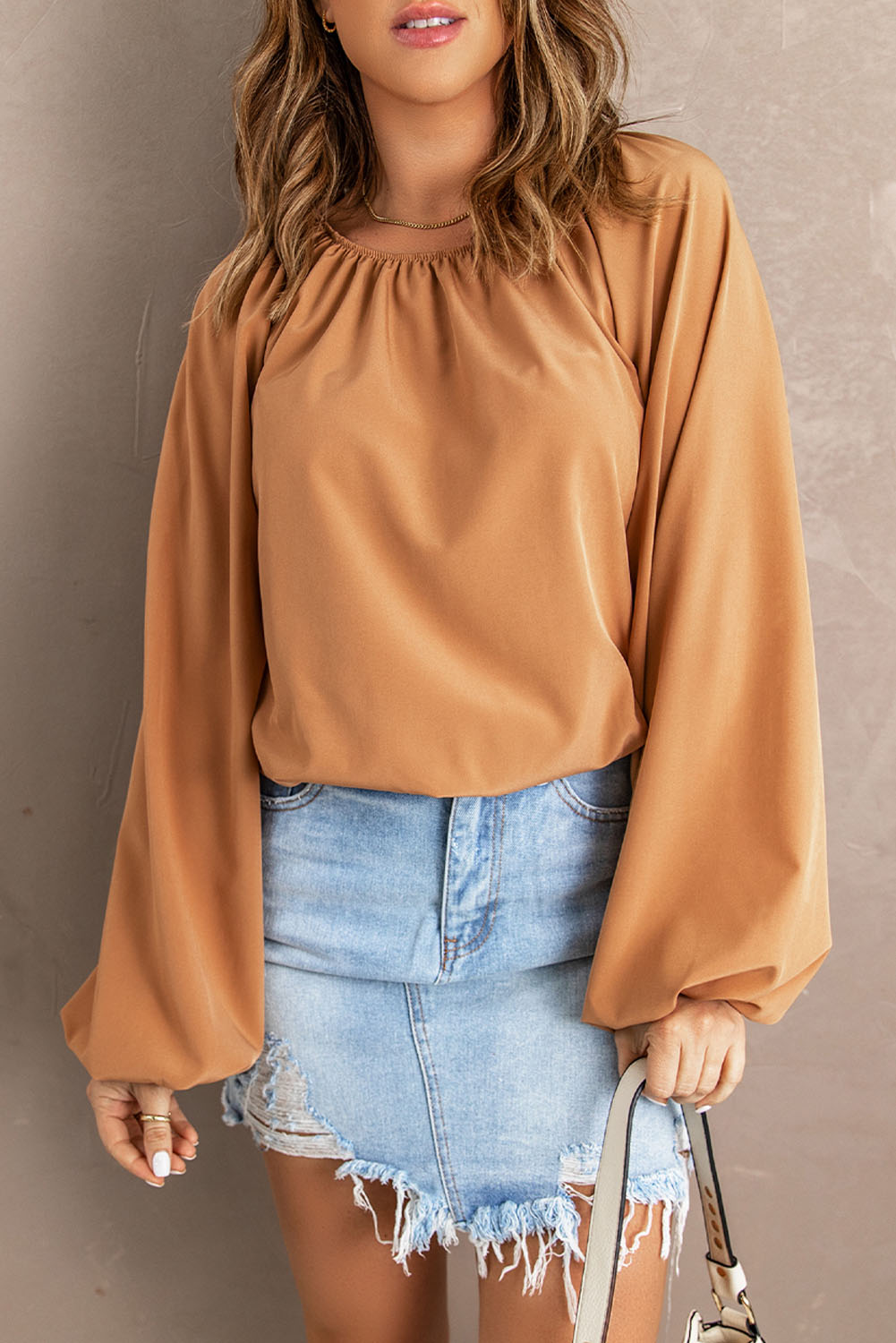 A stylish Lantern Sleeve Loose Blouse featuring a relaxed fit, round neck, and bubble sleeves, perfect for modern women.