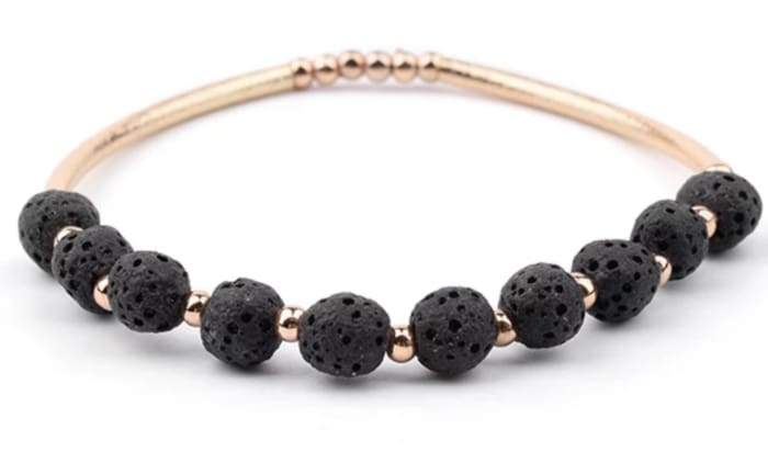 Lava Stone Essential Oil Bracelet featuring black lava stones and gold accents, perfect for aromatherapy.