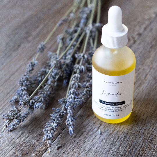 A frosted glass bottle of Lavender Body Oil with a dropper, showcasing its natural ingredients and calming lavender color.