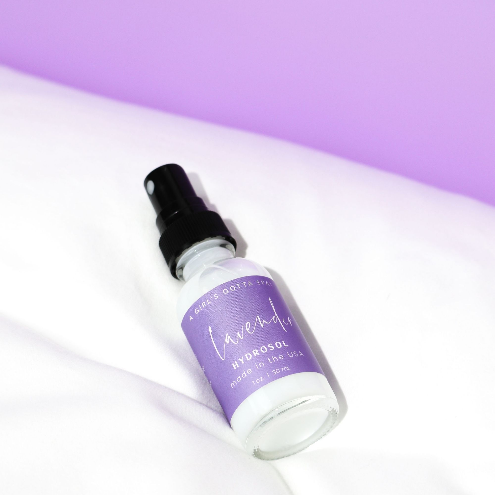 A bottle of Lavender Hydrosol Aromatherapy Pillow Spray with a calming lavender background, showcasing its natural ingredients.