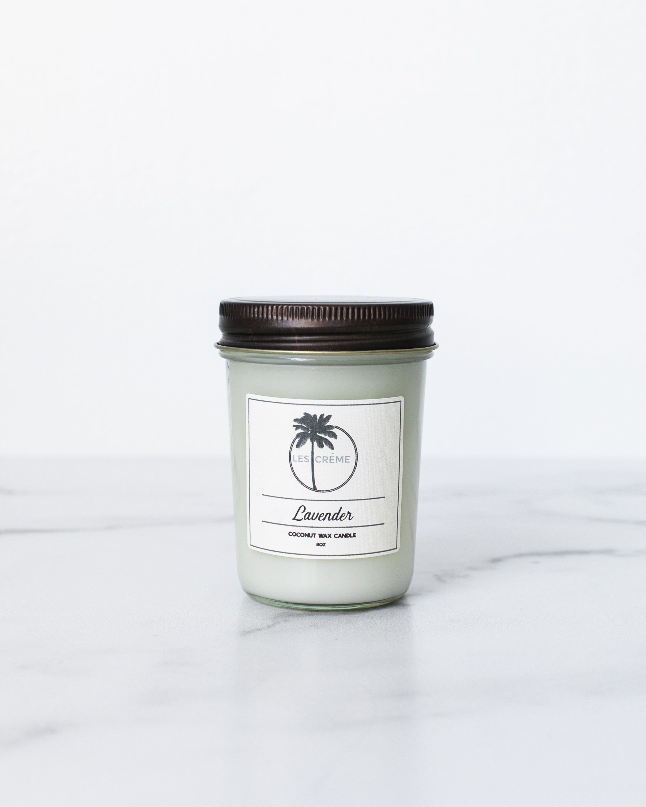 Lavender Scent Coconut Wax Candle in a glass jar, showcasing its natural ingredients and calming lavender color.