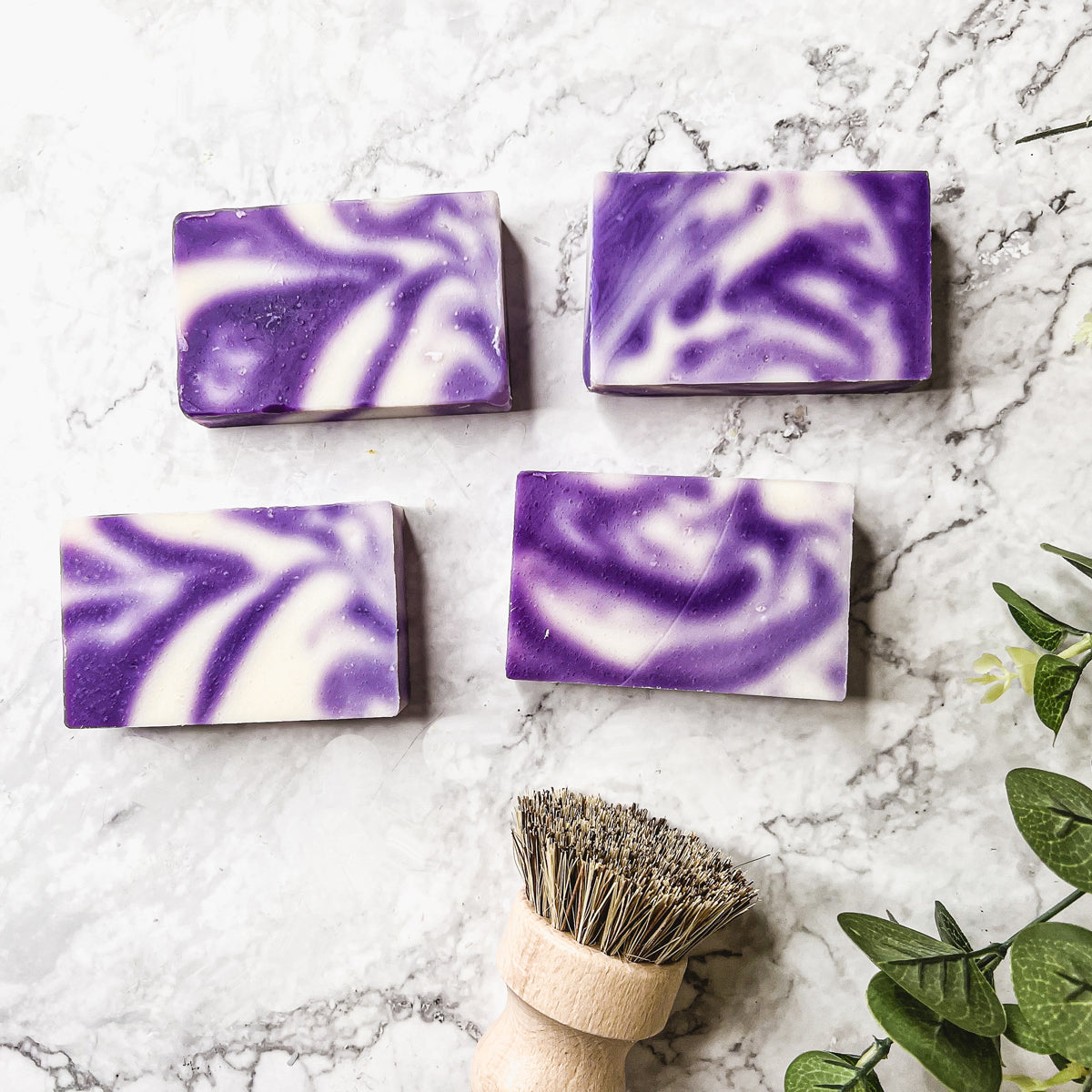 Lavender Swirl soap bar with a beautiful lavender color and unique handmade design, showcasing its organic ingredients and cold-pressed quality.