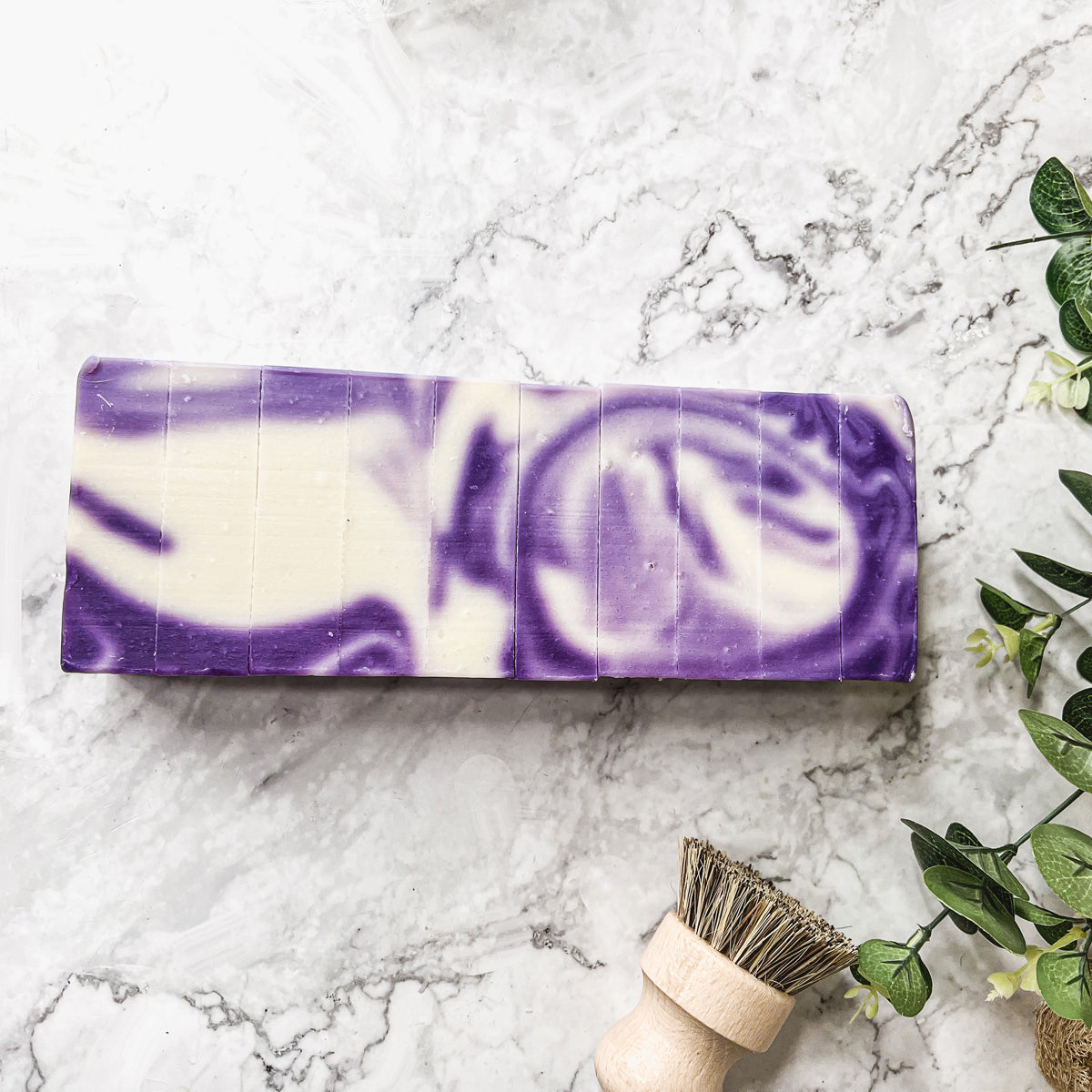 Lavender Swirl soap bar with a beautiful lavender color and unique handmade design, showcasing its organic ingredients and cold-pressed quality.