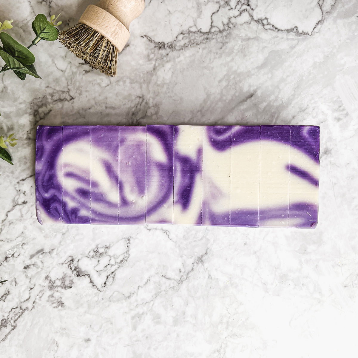 Lavender Swirl soap bar with a beautiful lavender color and unique handmade design, showcasing its organic ingredients and cold-pressed quality.