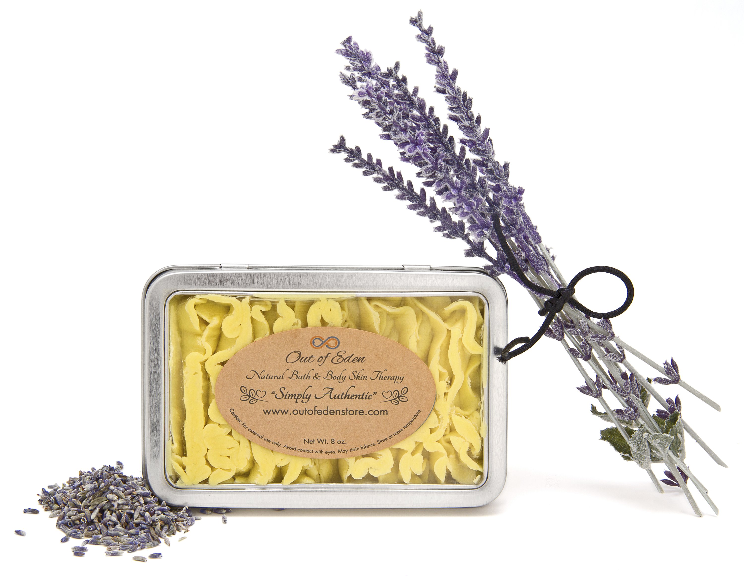 Lavender and Tea Tree Shea Cream in a jar, surrounded by lavender flowers and tea tree leaves, showcasing its natural ingredients.