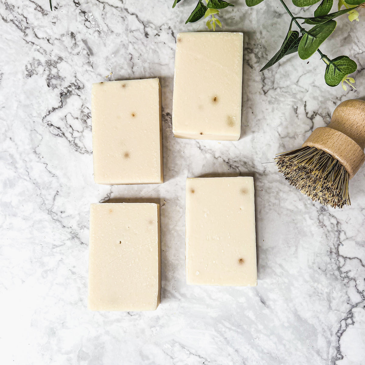 A handcrafted bar of Lavender Ylang Ylang soap featuring lavender buds and a blend of natural oils, showcasing its unique design and texture.