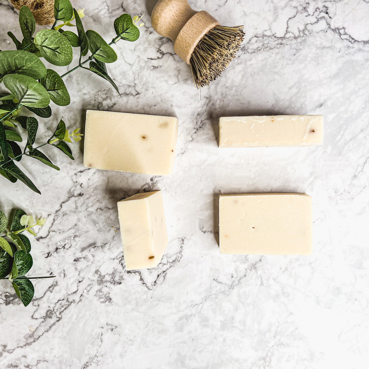 A handcrafted bar of Lavender Ylang Ylang soap featuring lavender buds and a blend of natural oils, showcasing its unique design and texture.