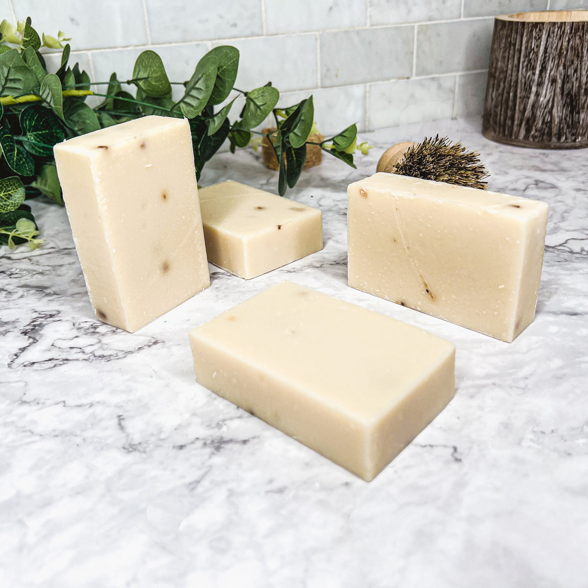 A handcrafted bar of Lavender Ylang Ylang soap featuring lavender buds and a blend of natural oils, showcasing its unique design and texture.