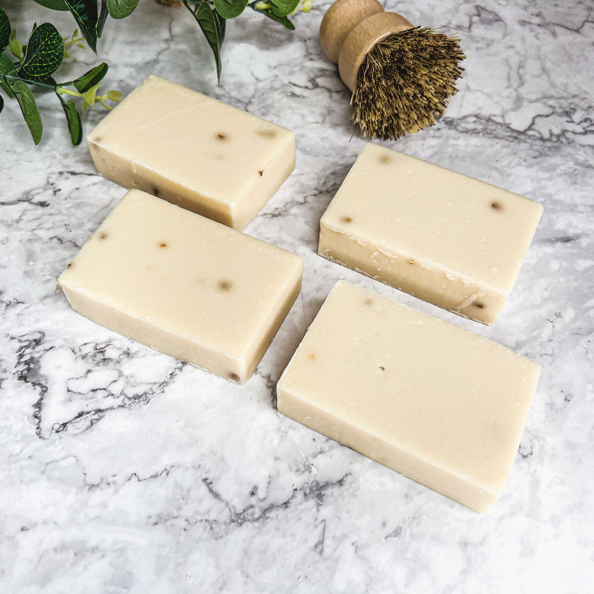 A handcrafted bar of Lavender Ylang Ylang soap featuring lavender buds and a blend of natural oils, showcasing its unique design and texture.